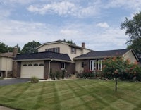 a house with a lawn and grass in front of it